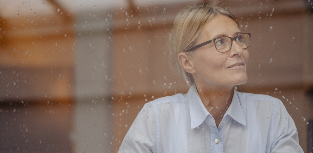 Woman looking into the distance, deep in thought.