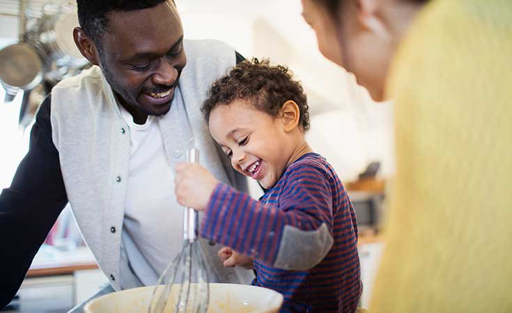 little girl baking with her parents