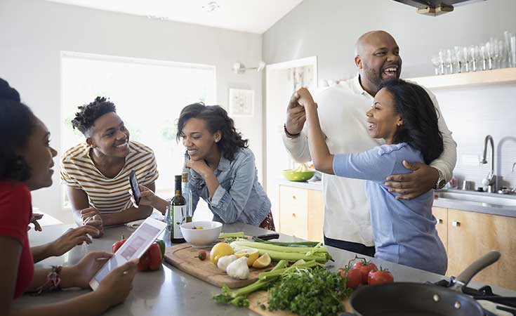 african american parents dancing and cooking