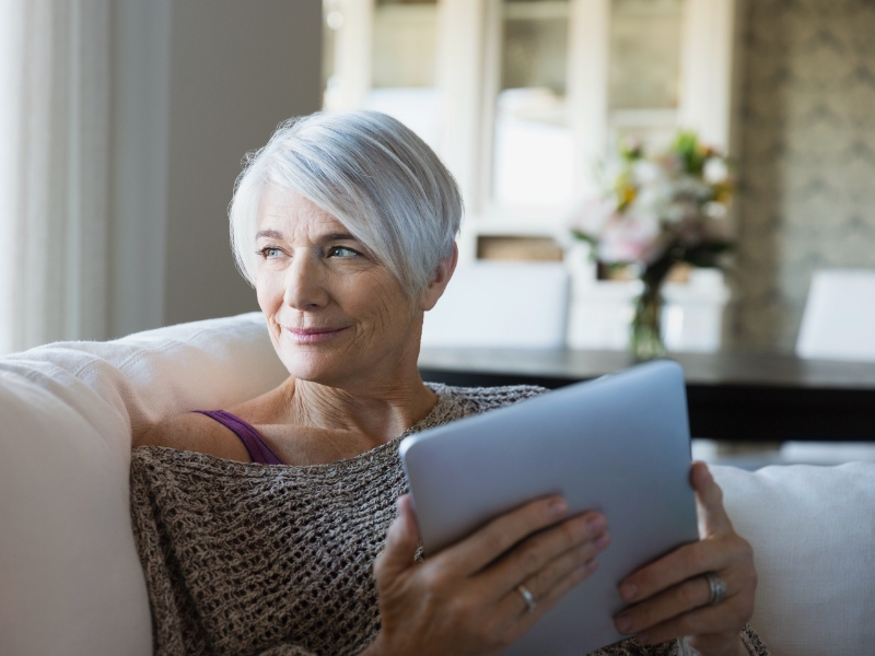 confident older white woman looking of a window