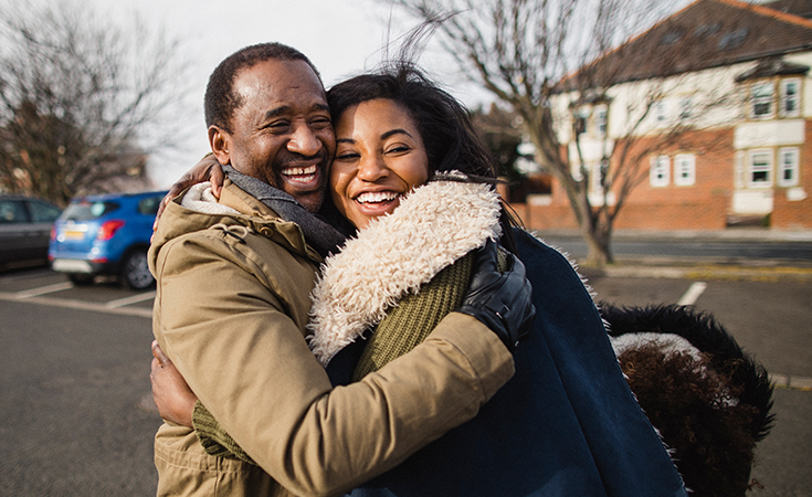 man and woman hugging each other while laughing