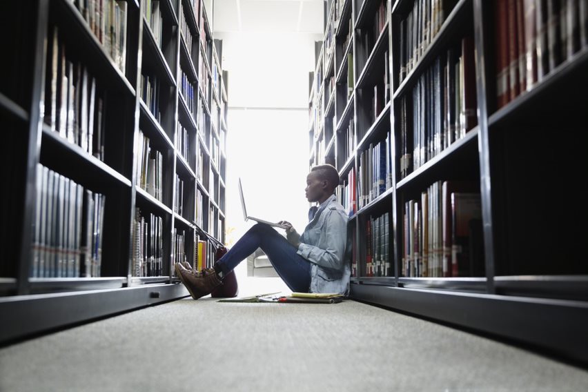 Lady sitting on the floor in the library