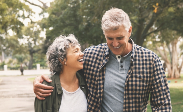 older couple embracing while walking outside