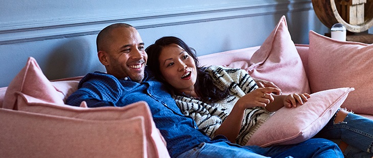 Couple laying on a sofa