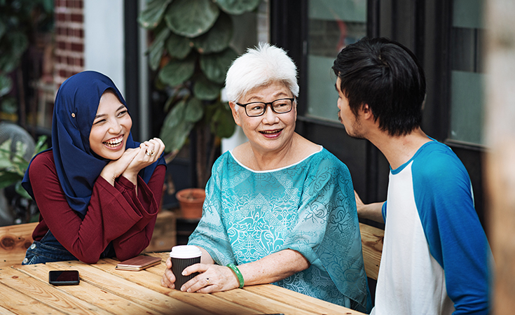 Multi-generation family gathered at table.