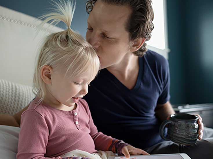 Life goals, father with young daughter as she reads
