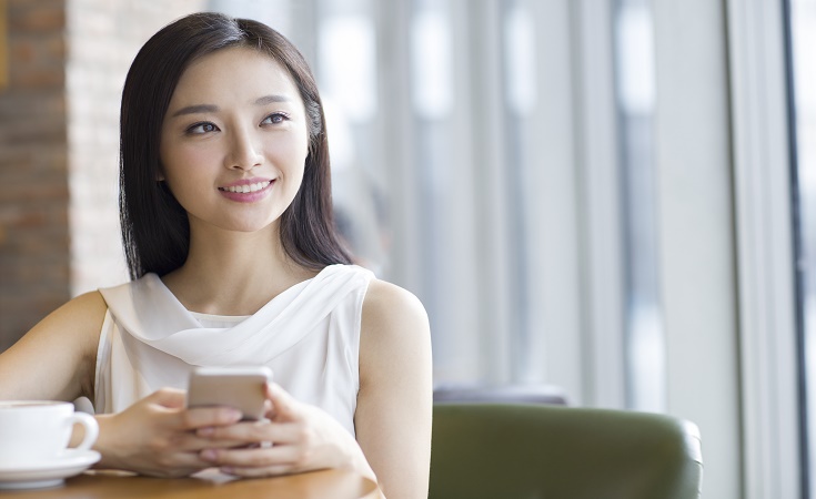 Woman sitting using phone